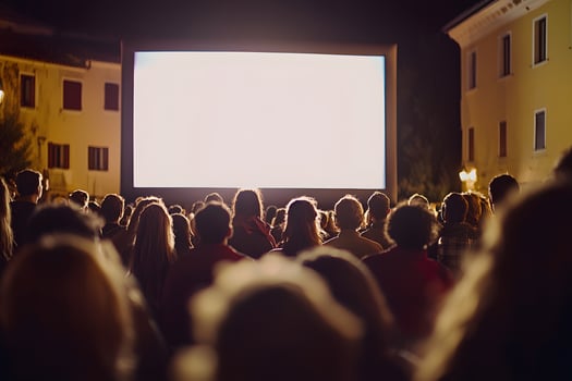 Outdoor Cinema Night Crowd Watching Movie on Large Screen at Night photo
