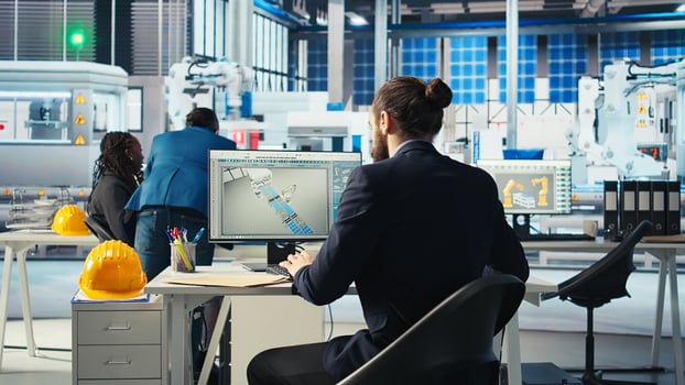 Photovoltaics expert looking over specifications on documents to ensure robot arms placing solar panels on assembly lines are running optimal. Specialist reads solar plant machinery paperwork photo