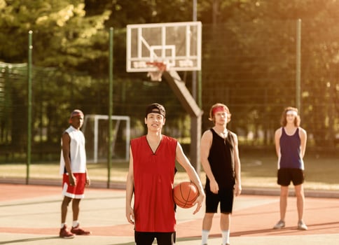 Asian basketball player with his team ready to play match at outdoor arena photo