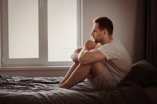 Anxiety Concept. Depressed Man Thinking About Problems Sitting In Bed Indoors. Free Space For Text photo