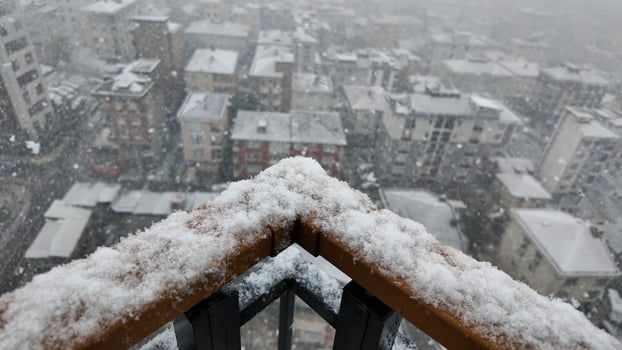 Snow covers urban rooftops in a winter city landscape photo