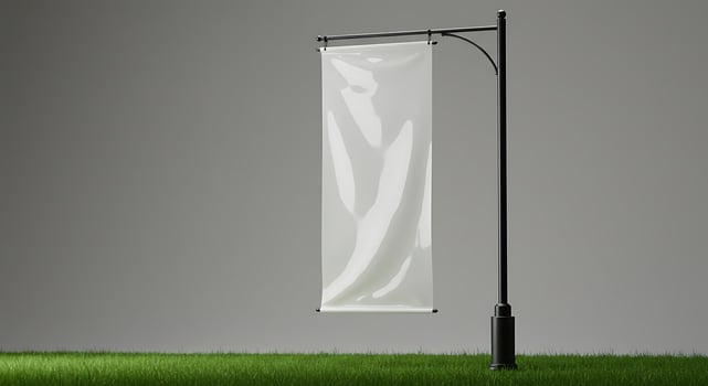 Blank Banner Mockup on Pole Standing in Green Grass Field photo