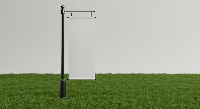 Blank Scroll Mockup Display on a Pole Standing in the Grass photo
