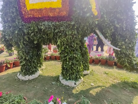 A large elephant made of flowers and plants photo