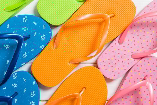 a lot flip flop colored sandals,summer vacation on wooden background, copy space top view photo
