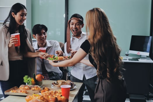 A group of people eating pizza and drinks photo