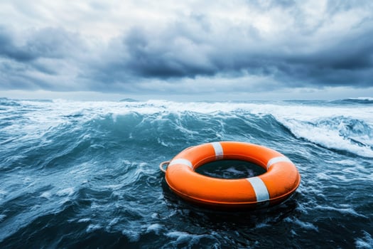Lifebuoy floating in turbulent ocean waters under a cloudy sky photo