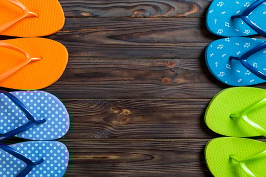 a lot flip flop colored sandals, summer vacation on wooden background, copy space photo