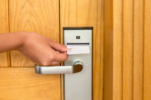 Close up ofemale hand hold key card and open electronic lock door photo