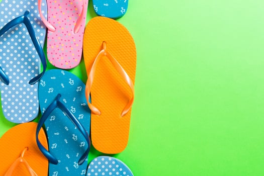 lot of flip flop colored sandals, summer vacation on colored background, copy space top view photo