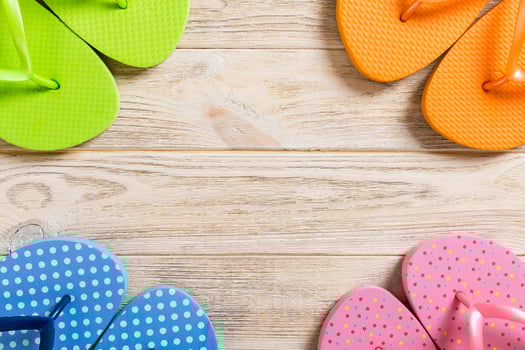 a lot flip flop colored sandals, summer vacation on wooden background, copy space top view photo
