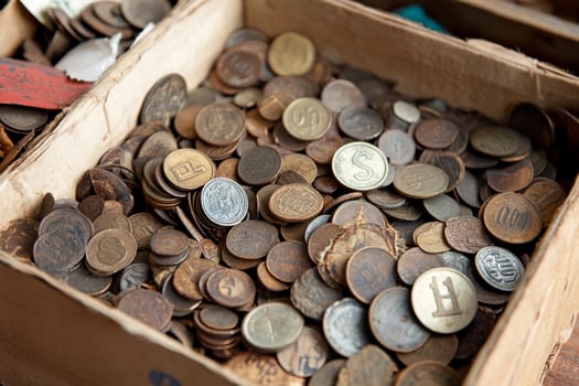 A box filled with old coins on a table photo