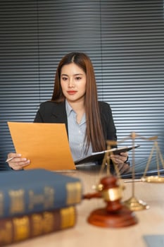 Legal Preparation and Document Review. Attorney analyzing case files in a focused manner. photo