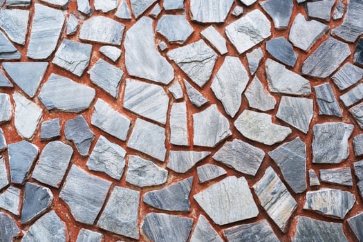 Detail of a stone wall with different size of rocks.. photo