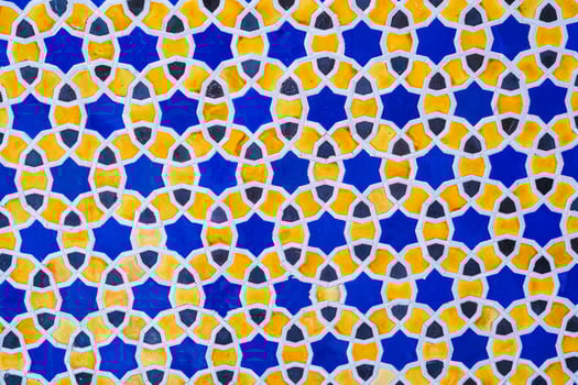 yellow and blue ceramic tiles with an abstract geometric pattern. Background with uzbek ornament photo