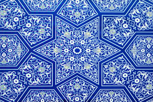 ceramic tiles with traditional Uzbek oriental pattern in Uzbekistan. Blue decorative background with Islamic ornament photo
