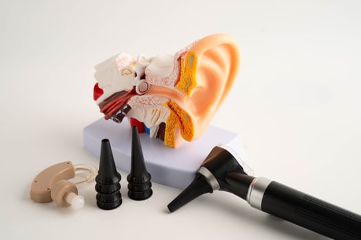 Otoscope with ear model for otolaryngologist or ENT physician doctor examining senior patient ear, hearing loss p photo
