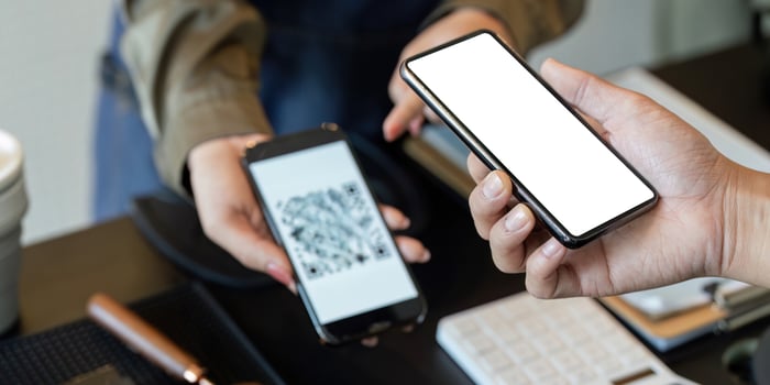 Digital Payments and Sustainability. A customer using their smartphone for contactless payment. photo
