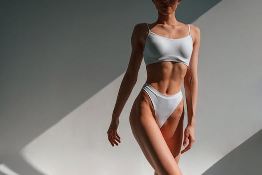 Close up view of the body... Young caucasian woman is indoors in the studio photo