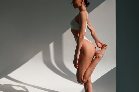 Slim body shape. Young caucasian woman is indoors in the studio photo