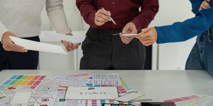 Idea Development and UX Strategies. Team exploring ideas for user experience strategies with sketches and digital tools. photo