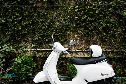 Bangkok, Thailand - March 26, 25 White vespa LX125 parked with white helmet. photo