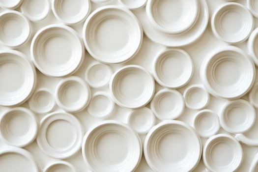 A wall of white plates with circles on it photo