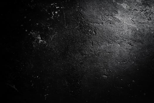 Dark, textured surface with a shadowy light photo