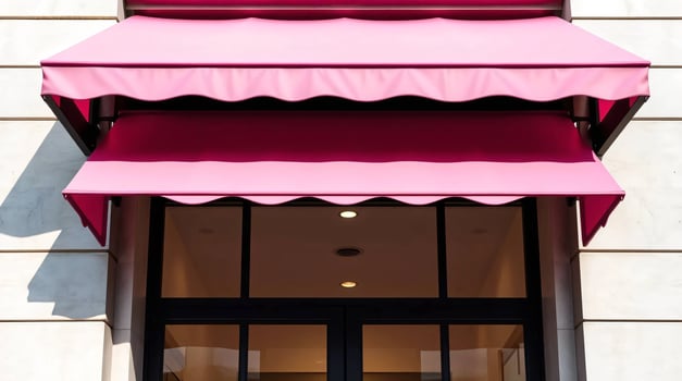 A pink awning is hanging over the entrance to a building photo