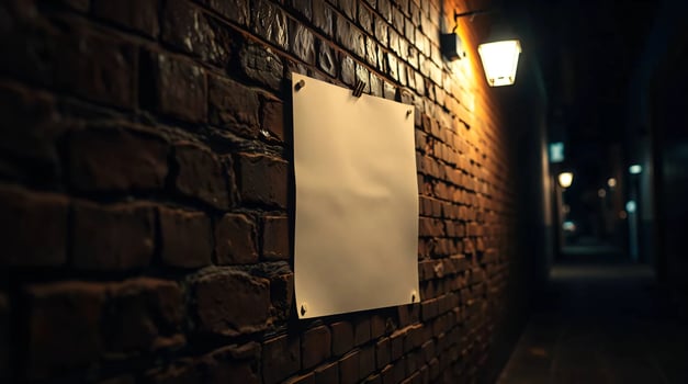 A white sign on a brick wall in a dark alley photo