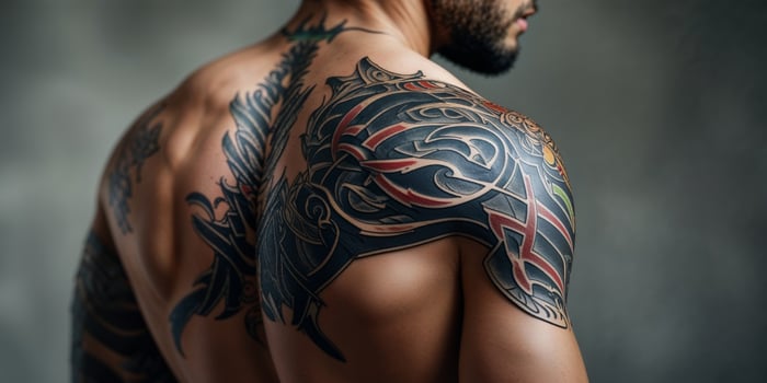 Intricate Tribal Tattoo on a Man's Back and Shoulder. photo