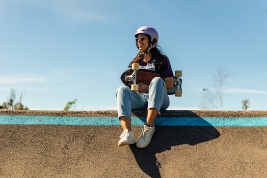 Latin skater woman holding surfskate on pump track photo