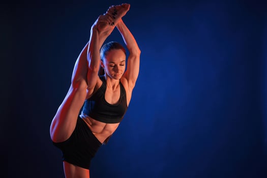Fitness, exercises. Beautiful muscular woman is indoors in the studio with neon lighting photo