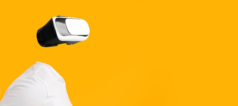 A user engaged in virtual reality without visible head or face, immersed in augmented reality. The bright yellow background enhances the futuristic feel of this technology-driven experience. photo