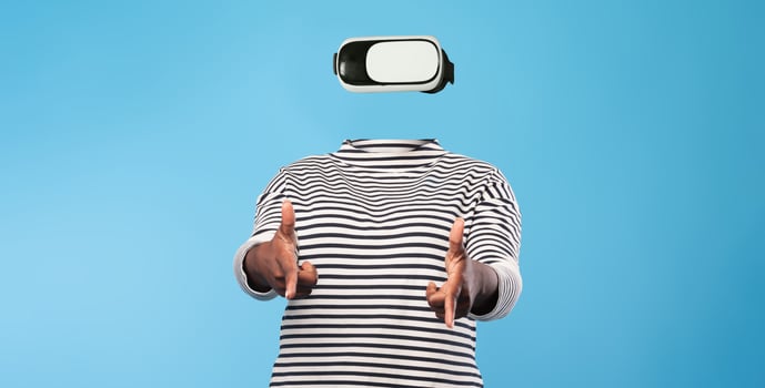 A person engages with virtual reality technology while wearing a headset. The individual has no visible facial features, emphasizing the device. The background is a solid color. photo
