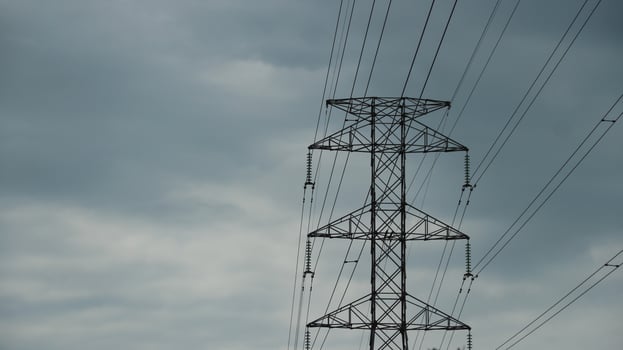 This is tall transmission line tower on clear blue sky background. photo