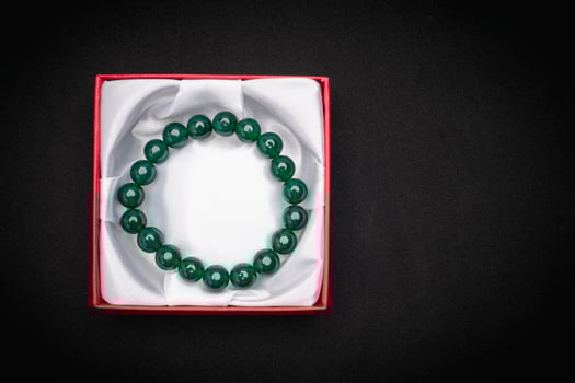 Jade bangle or bracelet in a red box on a black background photo