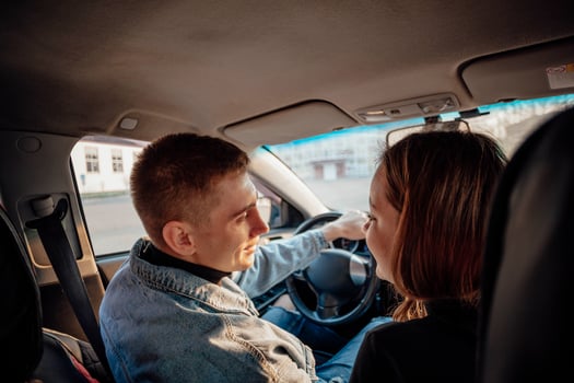 Young couple discussing their route in the car. love on a travel photo