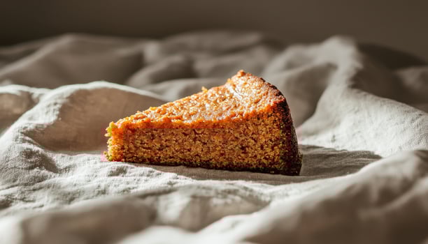 Delicious Cake Slice on Soft Fabric Background Copyspace for Text Natural Light Minimalist Style photo