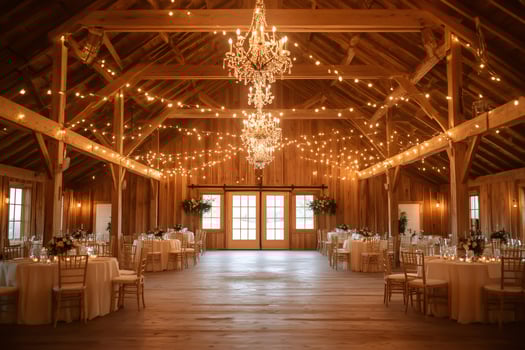 Elegant barn wedding reception venue setting with fairy lights and chandeliers photo