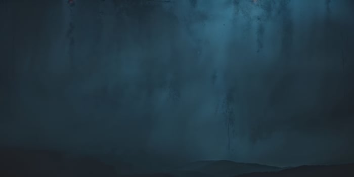 A dark cave with a waterfall and a man standing in front of it photo