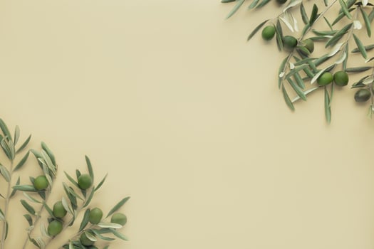 Olive branches and green olives on a soft yellow background photo