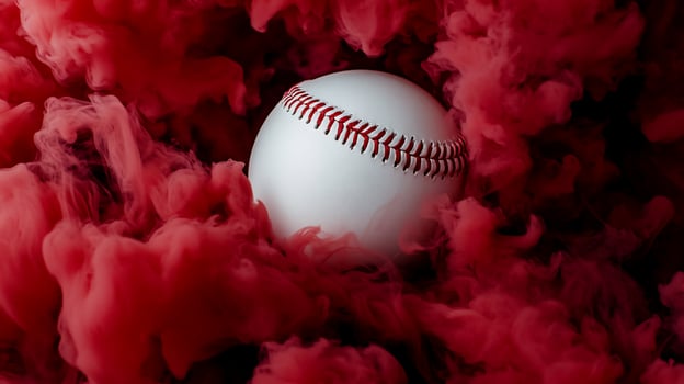 A baseball is in a red smokey background photo