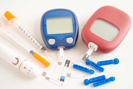 Glucometer lancet and test stick measuring human blood sugar level for diabetes. photo