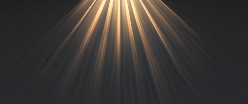 A light beam is shining down on a dark background photo