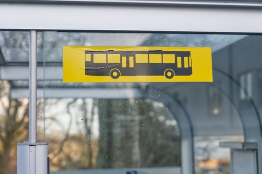 Yellow Bus Stop Sign on Glass Panel photo