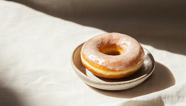 Delicious Glazed Donut on a Ceramic Plate Soft Background Copyspace for Food Lovers photo