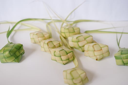 Ketupat traditional Southeast Asian rice cake on white surface photo