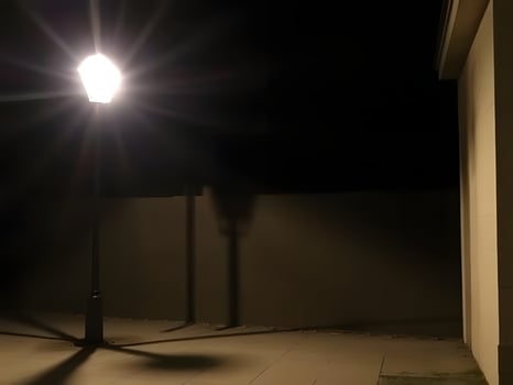 A street lamp is lit up at night photo
