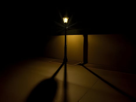 A street lamp casts a shadow on the ground photo